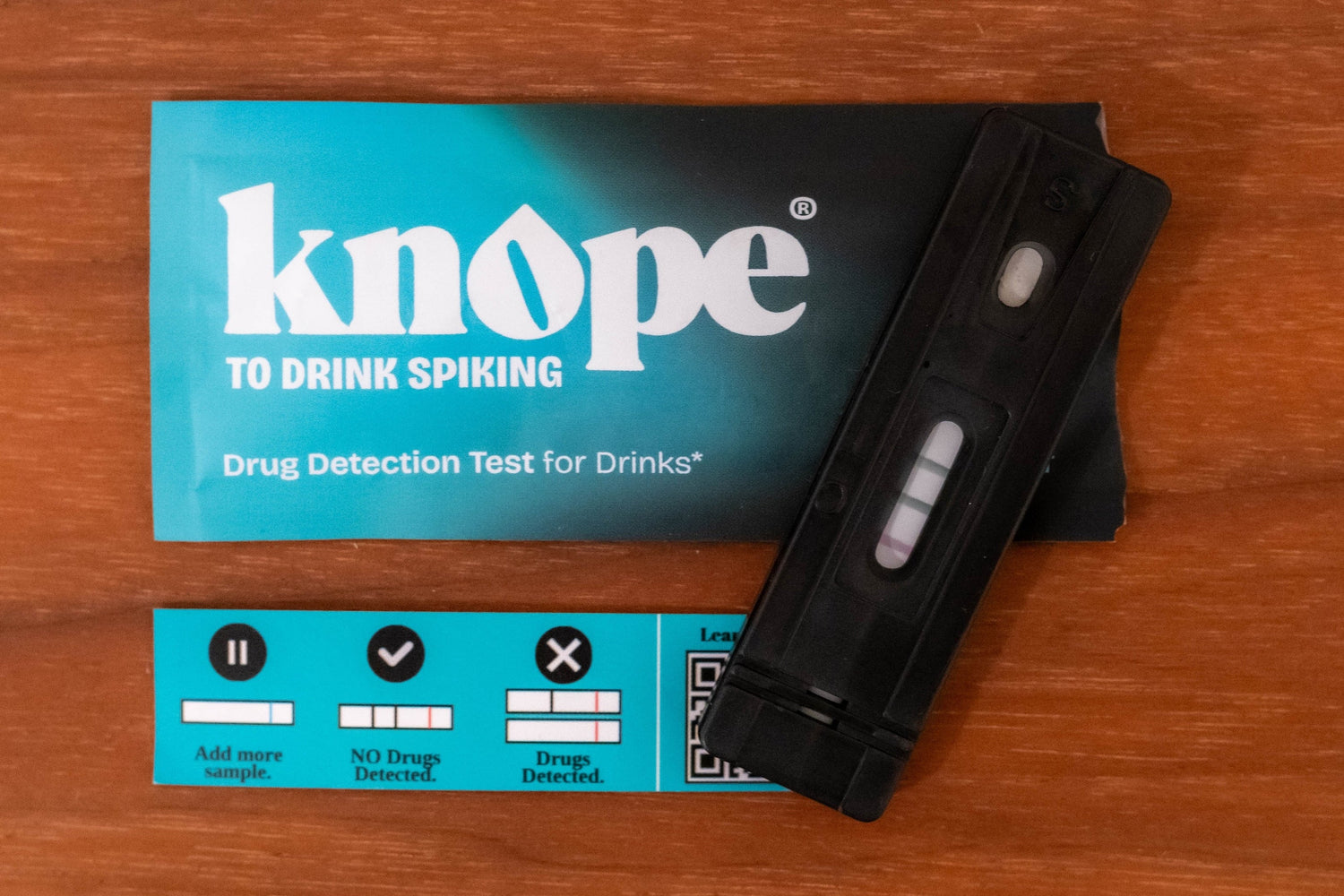 Knope drug detection test device with three lines on a wooden surface with instructions
